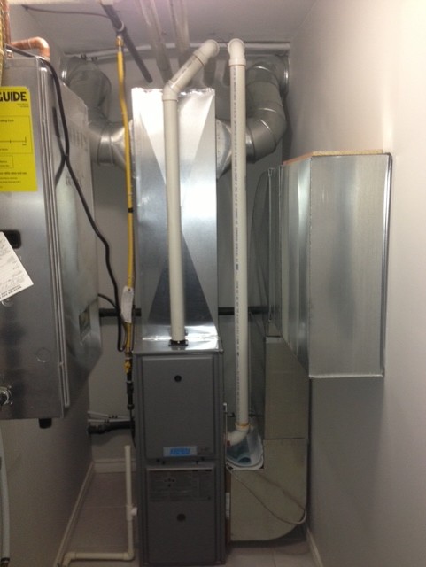 Compact mechanical room with NTI boiler and hydronic piping.