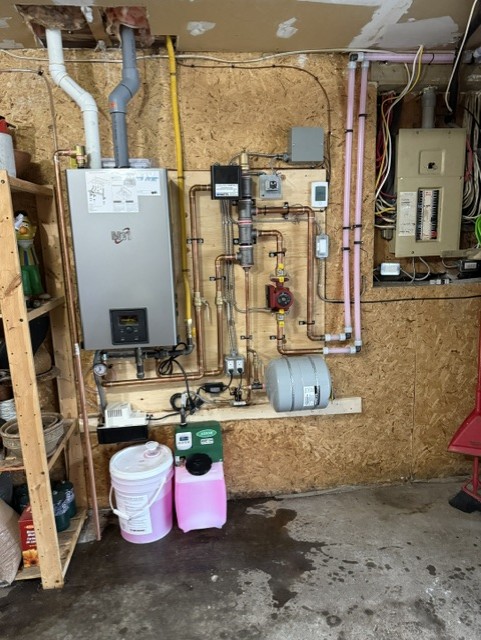 Hydroflame boiler and hydronic piping installation in a mechanical room.