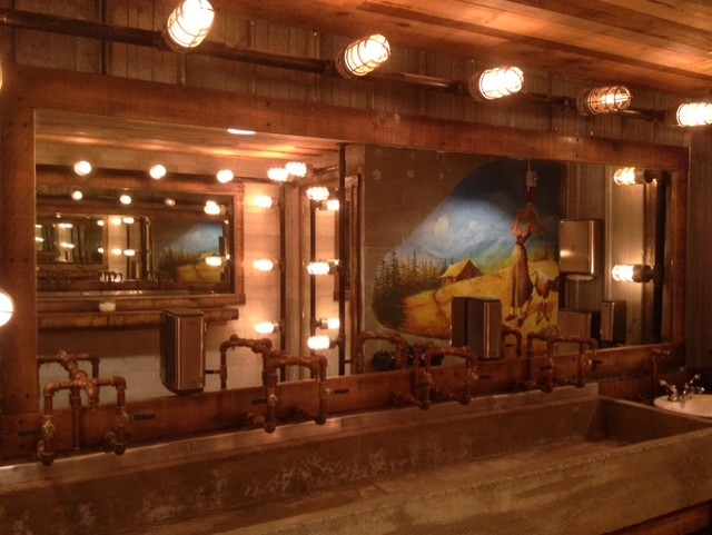 Decorative lighting fixture built from threaded pipe.