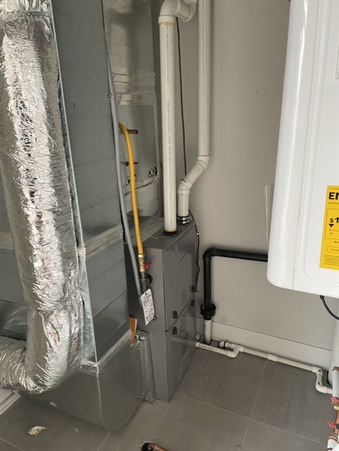 Mechanical room with multiple boiler units for a multi-unit building.