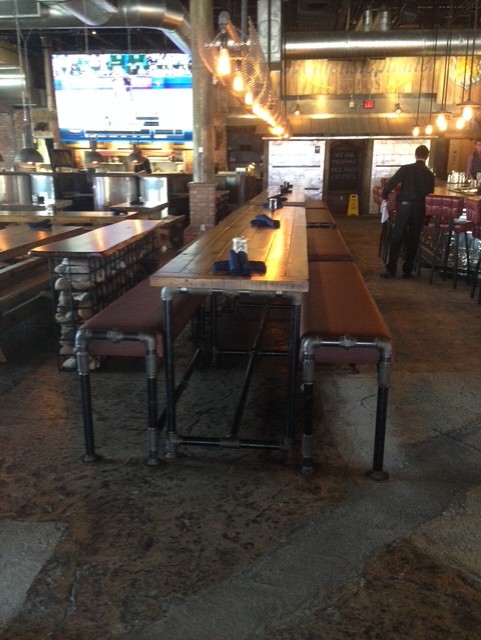 Restaurant bench and table built from threaded pipe fittings.